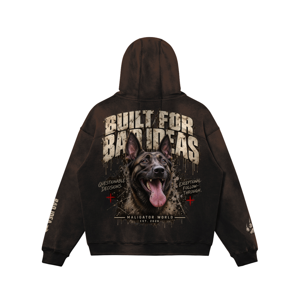 A dark brown hoodie shown from the back, featuring a large graphic print of a Malinois dog with the text 'BUILT FOR BAD IDEAS' and smaller text including 'QUESTIONABLE TRUTHS' and 'EXISTENTIAL FLOWING FORMULA'.