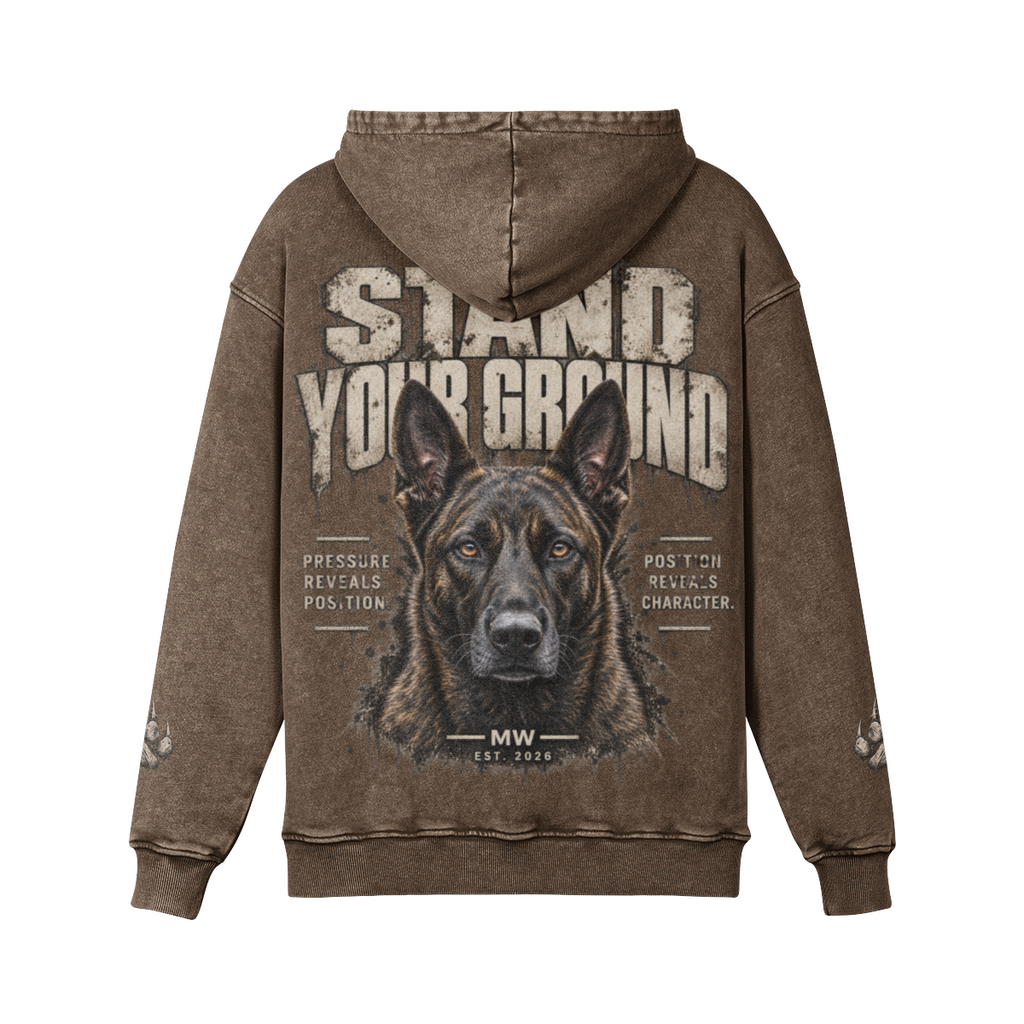 A brown acid-wash hoodie shown from the back, featuring a large graphic print of a Shepherd dog's face with the text 'STAND YOUR GROUND' and smaller text elements, on a plain white background.